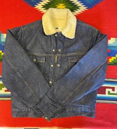 "Vintage 70's Sears Roebucks denim sherpa lining jacket size 36R. Two chest pockets, snap buttons closure, sherpa lining. Nice jacket in good use condition made by Sears, Roebuck and Co. Please, check carefully the measurements, photos and description of the article before buying it, we do not accept changes or returns. Measuraments lying face down from outside: 19\" Across chest underarm to underarm. 17\" Shoulder seam to seam. 25\" Sleeve length from shoulder to cuff. 23\" Long, front middle t Western Style Cotton Winter Outerwear, Winter Outerwear With Pockets For Rodeo, Winter Rodeo Outerwear With Pockets, Western Style Winter Outerwear With Snap Buttons, Western Style Dark Wash Outerwear With Pockets, Western Denim Jacket With Pockets For Winter, Western Denim Outerwear With Pockets, Western Style Long Sleeve Denim Jacket For Winter, Western Style Medium Wash Denim Jacket With Pockets