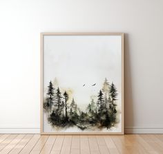 a watercolor painting of trees and birds in the sky on a white wall above a hardwood floor