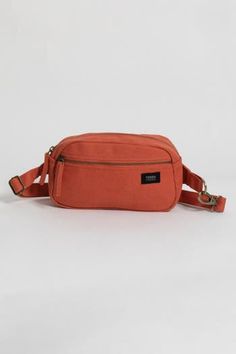 Not too big, not too small, wearable on your hip or as a tiny sling bag—this Cadera Fanny Pack is ready to roll when you are. Pack your essentials in this eco-friendly fanny pack made with organic cotton canvas when you want to move through the day with your hands-free. Bag: 6"(H) x 9"(W) x 2.5"(D) Made with 14-oz Certified Fairtrade Organic cotton canvas Long pull zipper Front pocket with zipper Inside pocket Detachable hook on one side for easy strap adjustments YKK lead-free antique finish me Cross Body Fanny Pack, Free Front, Feeding America, Antique Finish, Waist Bag, Free Bag, Sling Bag, Hands Free, Belt Bag