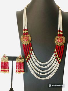 A beautiful pearl necklace with red beads have unique design is all set to dazzle your look at any party. This elegant necklace is a perfect which all women is looking for. Setting class of its own, it is a perfect necklace to be gifted as well as for personal use. Made with Pearl and red beads gold work. Long necklace pattern . Set include 1 set of earrings. Care instruction: Always keep your jewelry in a box or a pouch and keep it in a dry place. Keep it away from water, perfume and excessive heat. As soon as you remove it, thoroughly wipe each piece of jewelry with a soft, lint free cloth to maximize brilliance. if customization is required, plz feel free to contact me any time. All listings come in a professional gift box with a complimentary gift wrap option. Please advise if this is Red Beaded Necklaces With Dangling Beads For Celebration, Red Beaded Necklace With Dangling Beads For Celebrations, Red Long Beaded Necklaces For Party, Long Red Beaded Necklaces For Parties, Red Long Beaded Necklace For Party, Festival Pearl Drop Necklaces With Round Beads, Formal Pearl Chain Necklace For Festivals, Formal Pearl Chain Necklaces, Red Long Necklace For Party