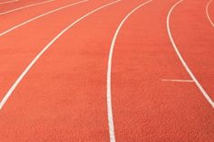 an orange track with white lines running along the side and one line in the middle