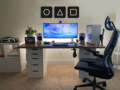 a desk with a computer monitor and speakers on it