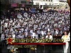 the band is standing in front of an audience holding a sign that says evans high school band