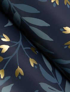 a blue and gold wallpaper with metallic leaves on it's side, as well as the background