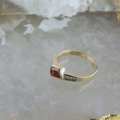 14K Yellow Gold Garnet and Diamond Ring, garnet rectangular offset 4 round diamond side stones, .25 inch across, Ring size 6.75, Circa 1970, 3.4 grams SKU # BB256R27 Most rings are sizable for a small fee. If the ring you are considering is the incorrect size contact us for a quote. This listing contains photographs of the actual item you will receive. Our items are in excellent condition with little or no signs of wear and many are one of a kind pre-owned estate finds. Please look closely at th Formal Multi-stone Rectangular Ring, Classic Multi-stone Princess Cut Rings, Vintage Rectangular Ruby Ring For Formal Occasions, Modern Garnet Rings For Anniversary, Gold Multi-stone Rectangular Ring, Classic Princess Cut Multi-stone Rings, Rectangular Birthstone Ring With Gemstone For Formal Occasions, Gold Garnet Jewelry With Diamond Accents, Modern Garnet Jewelry For Anniversary