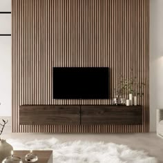 a living room with a large television on top of a wooden entertainment center next to a white rug