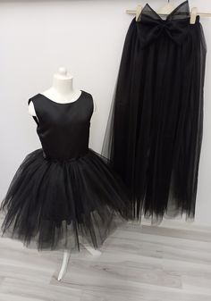 If you want, you can remove the tail and use it as a mini dress. It is a very functional tulle dress. Fitted Tulle Dress For Dress-up, Fitted Black Tulle Dress, Fitted Black Dress With Tulle Skirt, Black Fitted Dress With Tulle Skirt, Fitted Tulle Dress For Dress-up Occasions, Sleeveless Spring Tutu Dress For Costume Party, Stretch Tulle Evening Dresses, Fitted Tulle Mini Dress, Black Tulle Dress For Costume Party