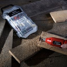 a person using a drill to fix a piece of wood