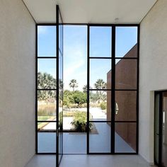 an empty room with large glass doors leading to the outside