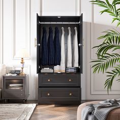 an open wardrobe with clothes hanging on it