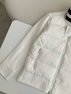 Experience the perfect blend of warmth and style with this Moncler-inspired Down-paneled Cotton Jacket in a refreshing white. This versatile piece seamlessly combines a quilted down-filled body with soft cotton sleeves, offering both exceptional insulation and freedom of movement. The classic white colorway is accented with a contrasting black inner collar and a bold logo patch, adding a touch of sporty sophistication. Whether you're seeking adventure or everyday comfort, this jacket is the perf Winter White Long Sleeve Quilted Jacket, White Quilted Jacket For Spring, White Quilted Casual Outerwear, White Nylon Puffer Jacket For Winter, Casual White Quilted Outerwear, Casual White Nylon Puffer Jacket, White Nylon Puffer Jacket For Fall, Casual White Puffer Jacket With Padded Collar, Sporty White Puffer Jacket For Winter