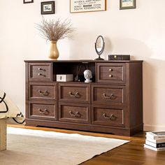 a wooden dresser sitting on top of a hard wood floor next to a white rug