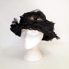 "Vintage 50's black picture hat made of braided cello straw, profusely decorated with black silk flowers and petals.  Flat-top crown and wire-edged brim.  Metal fastening comb on the inside band.  So chic and elegant.  No maker's label present.  S I Z I N G  printed sizenone fits like asmall circumference....20 1/2\" crown4\"  C O N D I T I O N  It appears there may be one flower missing at the very back.  MORE VINTAGE HATS  http://www.etsy.com/shop/JacquieVintage?section_id=6760142  BROWSE MY SHOP  http://etsy.com/shop/jacquievintage  CONNECT WITH ME  twitterjacquievintage facebookwww.facebook.com/JacquieVintage pinterestJacquie Vintage" Vintage Black Wide Brim Costume Hat, Vintage Black Costume Hat With Curved Brim, Vintage Black Cloche Hat For Evening, Black Brimmed Hat For Vintage Events, Black Vintage Cloche Hat With Curved Brim, Vintage Black Cloche Hat With Curved Brim, Vintage Black Hat For Evening, Vintage Black Top Hat For Church, Vintage Black Hat For Kentucky Derby