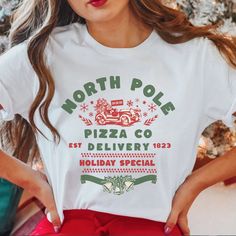 "Show off your festive spirit with a twist in our Funny Christmas Comfort Colors T-Shirt, featuring the playful \"North Pole Pizza Co Delivery\" design. This unique and comfortable tee is perfect for Christmas parties, casual holiday gatherings, or just wearing on a relaxed day during the festive season. Crafted from high-quality Comfort Colors fabric, this t-shirt offers a soft and cozy feel, making it a must-have for your holiday wardrobe. The amusing design is sure to bring smiles and laughter to everyone around you, making it an excellent gift choice for friends and family who enjoy a little festive fun. This Fun Pizza tshirt is also available in our shop as an ugly Christmas Sweater! Details- Comfort Colors introduces its garment-dyed t-shirt; a fully customizable tee made 100% with r Holiday Graphic Tee With Crew Neck, Christmas White Tops With Funny Print, White Christmas Graphic Tee Tops, White Christmas Graphic Tee, White Top With Funny Christmas Print, White Christmas Top With Funny Print, White Christmas Tops With Funny Print, Holiday Crew Neck Top With Funny Print, Holiday Graphic Print Crew Neck T-shirt