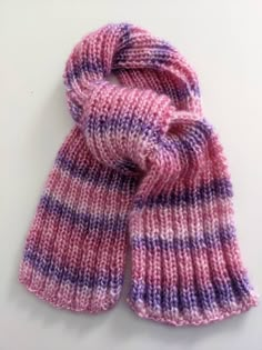 a pink and purple striped knitted scarf