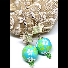 New Handmade Earrings Feature Upcycled Sky Blue Acrylic Beads With Fun Lime Green And White Floral Patterns. Whitewashed Silver Tone Metal Flowers And Light Green Crystal Bicones Complete This Fresh Look. Length Including Hooks 2.18”. Blue Flower Earrings For Summer, Blue Flower Dangle Earrings For Summer, Blue Flower Earrings With Ear Wire For Summer, Blue Flower-shaped Jewelry For The Beach, Blue Flower Jewelry For The Beach, Hypoallergenic Beaded Earrings With Round Beads For Summer, Turquoise Beaded Jewelry For Spring, Blue Flower Earrings For Beach, Adjustable Drop Flower Earrings For Beach