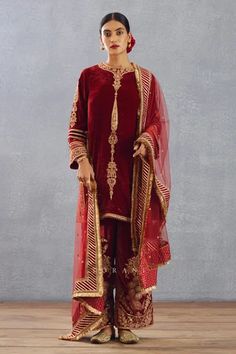 Bright red kurta with gold thread and sequin embroidered motifs. Comes with phiran and silk organza dupatta.
Component: 3
Pattern: Embroidery
Type Of Work: Thread, Gota Patti and Sequin
Neckline: Round
Sleeve Type: Full
Fabric: Silk Velvet, Cotton Voile and Silk Organza
Color: Red
Other Details: 
Dupatta with gota patti border and fringe detail
Side slits
Low back with tie and tassels
Phiran with embroidered hem
Occasion: Wedding - Aza Fashions Blouse Yoke, Red Kurta, Indian Textiles, Organza Dupatta, Embroidered Shorts, Silk Organza, Fabric Silk, Red Silk, Cotton Voile