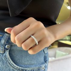 a woman's hand with a ring on top of her left arm and the other half of her finger