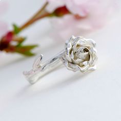 Engagement Ring, Sterling Silver Ring, Rose Flower Ring This makes a truly special gift for yourself or a loved one. Delicate silver rose ring handcrafted from sterling silver, the design features a beautiful open rose on a smooth rose stem. * Material: 925 Silver * Size of Rose: Approx. 1 cm (0.4 in) diameter and 0.5 cm (0.2 in) height * Ready to Ship in 2-3 business day * Made in the United Kingdom Every ring is individually handmade so that no two pieces are exactly the same. PACKAGING: Your Silver Wedding Ring With Roses, Silver Flower Ring With Roses For Wedding, Rose Design Rings For Valentine's Day, Silver Flower Ring With Rose Design, White Gold Flower Ring With Rose Design For Anniversary, Silver Flower Ring With Roses For Gift, Anniversary White Gold Flower Ring With Rose Design, Rose Design Flower Ring For Gift, Delicate Rose Design Rose Colored Ring