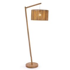 a wooden floor lamp with a shade on it