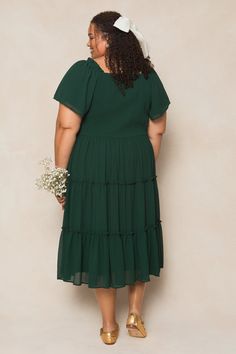 The perfect bridesmaids dress has entered the chat. Introducing our Ellie Dress in Emerald Chiffon! Made from luxurious chiffon fabric, this women's dress features a square neckline with ruffle detailing at the shoulder for a touch of elegance. The 1/2 length flutter sleeves add a playful touch, while the pull-over style with a smocked bodice make it nursing friendly and maternity friendly. The midi-length skirt and full lining add volume and movement to this must-have fall dress. Bridesmaid Midi Dress With Sweetheart Neckline And Ruffles, Elegant Chiffon Dress With Square Neck, Formal Chiffon Dress With Square Neck, Formal Square Neck Chiffon Dress, Fitted Chiffon Dress With Square Neck For Garden Party, Flowy Chiffon Bridesmaid Dress With Pleated Bodice, Ruched Chiffon Bridesmaid Dress, Flowy Midi Dress For Bridesmaids, Chiffon Bridesmaid Dress With Ruched Bodice