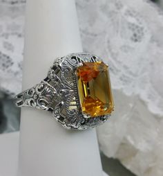 Natural Yellow Citrine Ring Intricate Design#149 Custom Made Inspired by Victorian era designs, I now offer this lovely filigree reproduction in sterling silver. This is a flawless natural citrine is 12mm by 10mm in L&W. The ring is 3/4th of an inch NS on the finger. The inside of the band is etched 925. Notice the intricate and detailed Victorian design of the antique patina silver filigree setting all the way down the band. This is an exquisite rendition of an antique filigree ring.... and Victorian Filigree Ring With Gemstone For Wedding, Victorian Filigree Gemstone Ring For Wedding, Formal Jewelry With Intricate Topaz Design, Victorian Filigree Gemstone Wedding Ring, Wedding Filigree Ring With Topaz Gemstone, Victorian Filigree Gemstone Ring For Anniversary, Antique Filigree Ring With Accent Stones For Gift, Vintage Filigree Ring With Accent Stones As Gift, Topaz Rings With Intricate Design For Anniversary