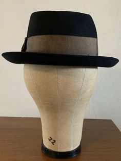 "For your consideration Vintage 60s era CHAMP KASMIR Finish black fedora hat Gold wide grosgrain ribbon 2\" wide Leather sweatband Shows some light dust from storage & minor wear .. couple minor indentions (top crown and large one on side crown) .. interior liner shows age with light dust and soiling , nicely broken in and very handsome! 100% Fur felt Manufacturing tag on inside sweatband Tag marked size 7 1/8 or 57 cm or Medium Shown on vintage size medium mannequin 2.\" brim 4\" crown 6 2/ Retro Fitted Fedora With Curved Brim, Black Hat Bands For Kentucky Derby With Curved Brim, Retro Fitted Fedora With Brim, Retro Fitted Brimmed Felt Hat, Fitted Retro Fedora With Curved Brim, Classic Black Top Hat For Kentucky Derby, Retro Adjustable Fedora For Formal Occasions, Fitted Fedora With Short Brim For Derby, Adjustable Retro Fedora For Formal Occasions