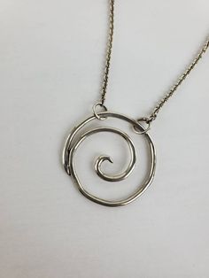 Sterling silver spiral pendant. Measures 1 1/4 x 1 1/4 inch. Has an attached 16 inch chain. Designed and handcrafted by Richelle Leigh using the lost wax casting process. Free shipping US. https://www.etsy.com/shop/RichelleJewelry Spiral Hand Forged Sterling Silver Jewelry, Unique Spiral Sterling Silver Necklace, Nickel-free Sterling Silver Swirl Necklace, Spiral Sterling Silver Jewelry With Oxidized Finish, Hand Forged Silver Swirl Jewelry, Handmade Spiral Silver Necklace, Handmade Silver Spiral Necklace, Hand Forged Silver Spiral Necklace, Sterling Silver Swirl Necklaces