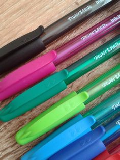 several pens are lined up on a table