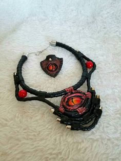 This is a unique necklace crafted from genuine leather, painted with acrylics, hand-painted dragon-eye stylized glass eye and natural stone coral, this unique necklace will protect you from ill will and will give you compliments from anyone who sees it. To see more of my products visit my page in Instagram https://www.instagram.com/mariyana.sobol Black Jewelry For Halloween Fantasy Events, Fantasy Pendant Necklace For Cosplay, Red Fantasy Jewelry For Cosplay, Fantasy Necklaces For Halloween Festival, Fantasy Jewelry For Halloween, Handmade Gothic Jewelry For Festivals, Handmade Pendant Jewelry For Cosplay, Handmade Black Necklace For Cosplay, Fantasy Festival Choker Jewelry