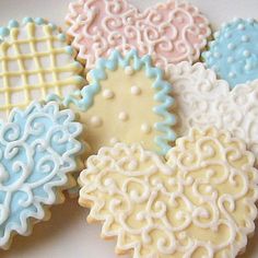 four decorated cookies sitting on top of a table