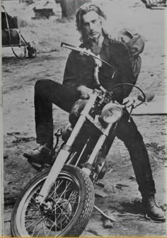 an old photo of a man on a motorcycle