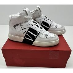 Valentino Garavani's Mid-Top Vl7n Sneakers Are Crafted From Premium Italian Calfskin Leather. Accented With Black Bands, These Size 43 Or Us 10 Shoes Define Luxury. Valentino Garavani Vl7n Mid Top Sneakers In White - White. Size 43 Or Us 10. Calfskin Upper With Rubber Sole. Made In Italy. Lace-Up Front. Seven Bands With Rubber-Effect Vltn Logo. Valentino Garavani Heat-Engraved Logo On The Back And The Tongue. Perforated Detail. Round Toe. Zy2s0e03 Y0s0e03wrq. Msrp $1150 Sold Out! About The Desig Luxury High-top Lace-up Sneakers With Logo, Luxury Lace-up High-top Sneakers With Logo, Luxury White High-top Sneakers With Logo, Luxury White Calf Leather High-top Sneakers, Designer White High-top Sneakers With Logo, Designer White Calf Leather Sneakers, Designer Calf Leather Sneakers With Perforations, Custom Leather Sneakers With Logo, Custom Leather Sneakers With Logo And Round Toe