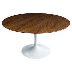 an oval wooden table with white base