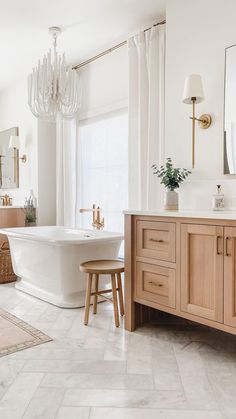 a bathroom with a large tub and wooden cabinets