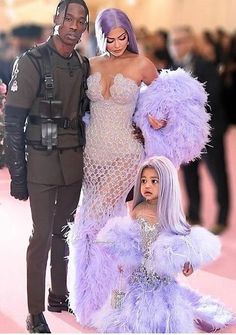 the couple are dressed up as they pose for a photo with their daughter, who is wearing