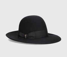 The Eleonora hat is a timeless symbol of Borsalino excellence. The model is made from superior quality smooth folar felt, known for its smooth finish and soft touch, ensuring superior comfort and durability over time. This hat is unlined and offers a light and comfortable fit. The design features an open crown and a 4 cm wide grosgrain ribbon. The brim is wide and measures approximately 8 cm. Each Borsalino felt hat takes seven weeks to be handcrafted by our skilled artisans at the Maison in Alessandria, whose passion and craftsmanship are expressed in every single piece. The Borsalino handmade production process involves more than 50 steps and is passed down from generation to generation. Composition: 100% Felt Classic Wide Brim Felt Hat For Evening, Classic Wide Brim Hat For Evening, Adjustable Luxury Hat Bands For Formal Occasions, Classic Brimmed Felt Hat For Evening, Chic Formal Hat Band With Flat Crown, Luxury Curved Brim Fedora For Formal Occasions, Luxury Flat Brim Hat For Formal Occasions, Chic Formal Hat Bands With Flat Crown, Elegant Fedora With Flat Crown For Formal Occasions