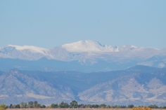 the mountains are covered with snow in the distance