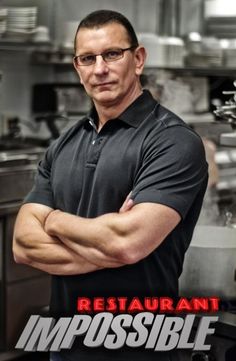 a man standing in front of a kitchen with his arms crossed