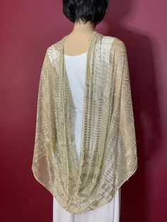 Here we present a really unique 1920s cream-colored Egyptian Assuit shawl that was probably a lovely young bride's wedding shawl. Wrap this wide, long motif-rich shawl around your head and shoulders and you are ready to travel down the historic Nile River feeling like a princess. The silver warms on the skin but it lets the breeze through making it the perfect compliment to your wardrobe.   There are some light markings on the net and a handful of small breaks (maybe 6 or 7)  all shown in photos but still very wearable. The silver and tulle are strong and resilient for a 100-year-old shawl. I just adore the bottom part of each end. We have not washed this and the light markings may lift when soaking. You can wear it just the way it is!  We will refund all shipping overages. 27 inches wide Gold Bollywood Shawl With Traditional Drape, Luxury Semi-stitched Bollywood Shawl, 1920s Egyptian Revival Fashion, Gold Embroidered Bollywood Shawl, 1920’s Shawl, Egyptian Fashion, Wedding Shawl, Vintage Cotton, Just The Way