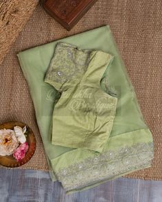 "The Pure Organza Pastel Green Saree Is A Delicate And Elegant Piece Of Clothing That Exudes Grace And Sophistication. The Subtle Pastel Green Base Adds A Touch Of Refinement To The Saree, Making It Perfect For Formal Occasions. The Saree Is Adorned With All-Over Hand Embroidery Over The Borders With Fine Threads Of Golden And Silver, Which Add A Touch Of Shimmer And Shine To The Saree. The Blouse That Comes With The Saree Is Heavily Embroidered , Which Perfectly Complements The Intricate Embroi Festive Semi-stitched Pista Green Blouse, Traditional Georgette Blouse For Eid, Semi-stitched Tissue Silk Blouse For Navratri, Pista Green Chanderi Blouse Piece For Weddings, Traditional Semi-stitched Chikankari Embroidery Blouse, Navratri Semi-stitched Chikankari Blouse, Bollywood Style Chanderi Blouse With Chikankari Embroidery, Bollywood Style Chikankari Chanderi Blouse, Fitted Cotton Silk Pre-draped Saree