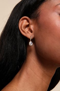 Add an expensive vibe to any date-night look with the Lulus Posh Drama Gold Rhinestone Teardrop Earrings! Shiny gold-toned metal shapes these stunning earrings that have a teardrop-shaped silhouette with a halo of clear rhinestones along the posts surrounding the rhinestone focals. Post Backs. 1" Long. 70% Brass, 30% Cubic Zirconia. Imported. Lulus | Posh Drama Gold Rhinestone Teardrop Earrings. Glamorous Teardrop Metal Earrings, Elegant Metal Teardrop Earrings For Parties, Glamorous Gold Teardrop Earrings For Formal Events, Glamorous Gold Teardrop Earrings For Evening, Glamorous Evening Teardrop Drop Earrings, Elegant Metal Drop Earrings, Elegant Pear-shaped Metal Earrings, Elegant Pear-shaped Crystal Earrings For Party, Gold Teardrop Cubic Zirconia Earrings For Formal Occasions