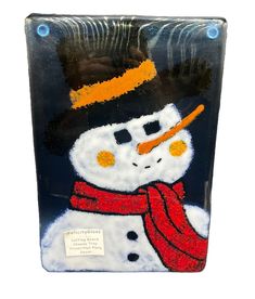 a frosty glass block with a snowman wearing a hat and scarf on it