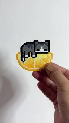 someone is holding up a pixelated piece of food