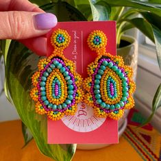 Our Monogem Earrings are a bold a fun statement to add to your fit! These colorful beaded earrings are handcrafted by our artisans in the heart of Mexico Lindo. Handmade Multicolor Beaded Earrings For Party, Colorful Handmade Fun Earrings, Fun Multicolor Jewelry For Crafting, Vibrant Colorful Beaded Jewelry, Colorful Vibrant Earrings With Ear Wire, Artisan Multicolor Beaded Earrings For Gift, Artisan Colorful Beaded Teardrop Earrings, Bold Colorful Beads Jewelry Gift, Bold Handmade Multicolor Earrings