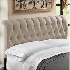 an upholstered headboard with white pillows