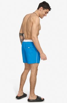 Soak up the sun in these recycled-fiber swim trunks built with quick-drying properties and UPF 40+ sun protection. 5" inseam (size Medium) Elastic/drawstring waist Front slant pockets; back patch pocket Lined 100% REPREVE polyester REPREVE recycled polyester is made from 100% post-consumer recycled plastic bottles Machine wash, tumble dry Imported Recycled Polyester Swim Trunks With Built-in Shorts For Beach, Blue Nylon Swim Trunks For Sports, Beach Swim Trunks With Upf 50+ And 4-way Stretch, Sporty Blue Moisture-wicking Swimwear, Upf 50+ 4-way Stretch Swim Trunks For Beach, Blue Uv Protection Bottoms For Beach Season, Blue Swim Trunks With Upf 50+ For Pool, Blue Moisture-wicking Summer Swimwear, Blue Nylon Swimwear With Go-dry Technology