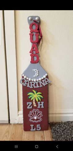 a wooden sign with the word florida on it and a palm tree hanging from it