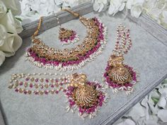 Nauratan Multi Necklace Set  With Tikka and Jhumkey with gorgeous saharey  Main colour is Champagne Gold, Pink with a combination of Gold and Green and White Beads. Stunning Set perfect for a Mehndi Function Bollywood Style Wedding Jhumkas With Peacock Design, Bollywood Style Peacock Design Jhumkas For Wedding, Temple Jewelry Sets With Peacock Design For Weddings, Multicolor Chandbali Bridal Sets For Wedding, Festive Temple Jewelry Bridal Sets For Party, Chandbali Kundan Necklace With Peacock Design For Wedding, Wedding Kundan Chandbali Necklace With Peacock Design, Peacock Design Jewelry Sets For Wedding And Diwali, Temple Jewelry Bridal Sets For Festive Party