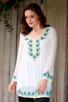 Floral motifs dazzle in perfect harmony as colorful glass beads grace this beautiful tunic by India's Sandip Agarwal. The white polyester blouse features the intricate hand-beading along the neckline, hem and sleeves. The top is lined with cotton. Spring Georgette Tops With Floral Embroidery, White Georgette Blouse For Eid, Long Sleeve Embellished Festive Tunic, Festive Embellished Long Sleeve Tunic, Multicolor Georgette Summer Blouse, Festive Long Sleeve Embellished Tunic, White Festive Tunic For Eid, Multicolor Georgette Blouse For Summer, White Floral Embroidered Tunic For Festive Occasions